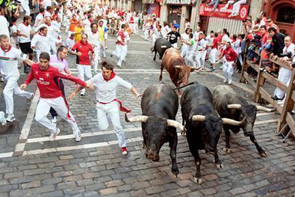 Jóvenes corriendo en los Sanfermines de Pamplona