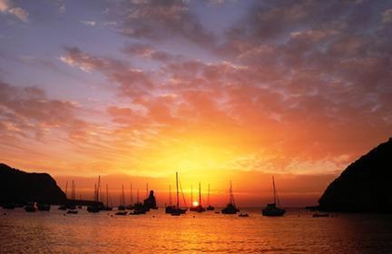 Atardecer junto al mar con las embarcaciones al fondo