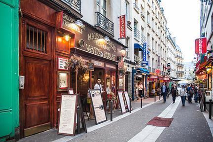 Calle comercial llena de restaurantes en el Barrio Latino de París