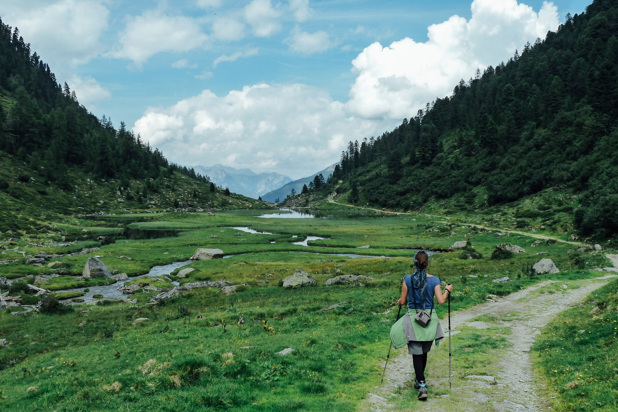 Mujer caminando por una pista en Pirineos